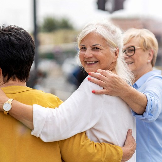 Group of women smiling while walking together outside