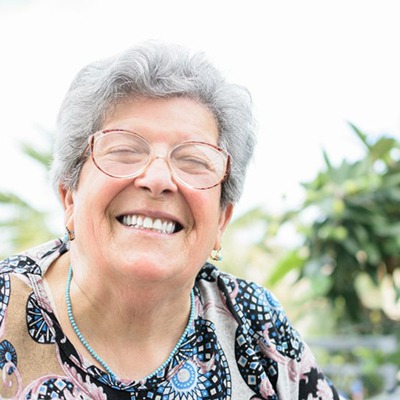 Woman smiling brightly outdoors