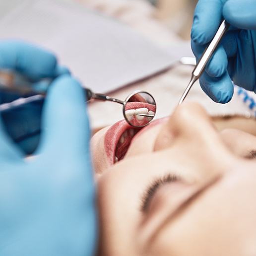 A dentist examining a patient’s smile
