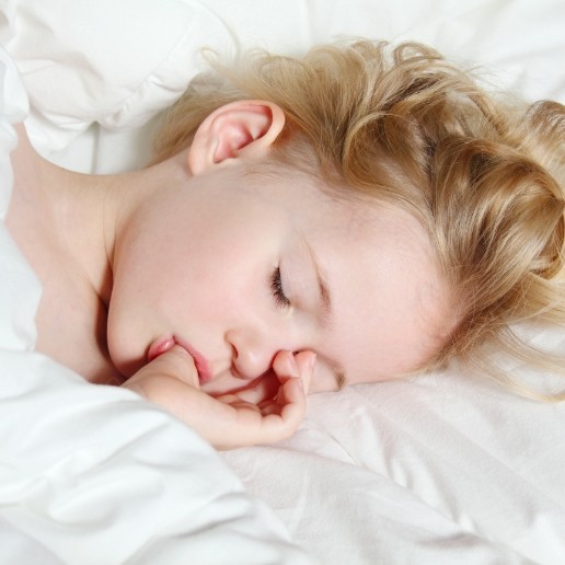 Young girl sucking her thumb while sleeping