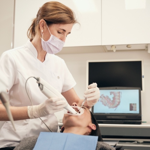 Dental team member taking digital images of a patient's mouth