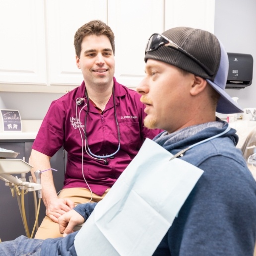 Doctor David Fried talking to dental patient in Merrillville