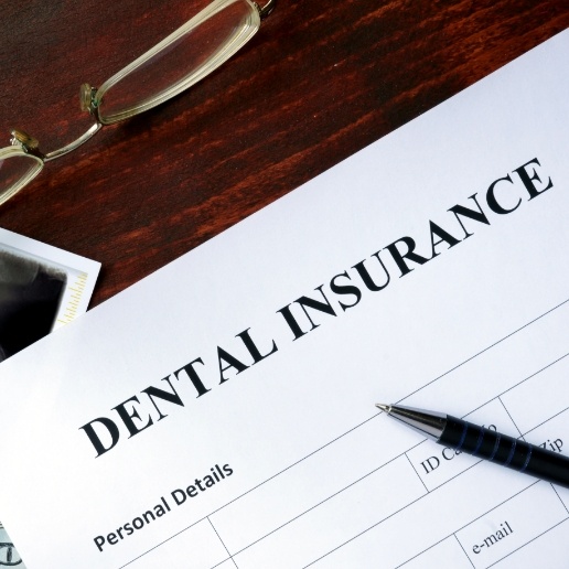 Dental insurance form on a dark wooden table