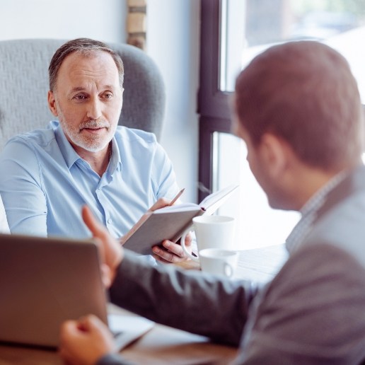 Two businessmen sitting discussing financing