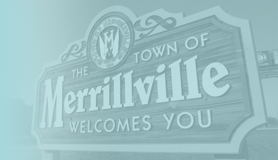 Wooden sign that says the town of Merrillville welcomes you