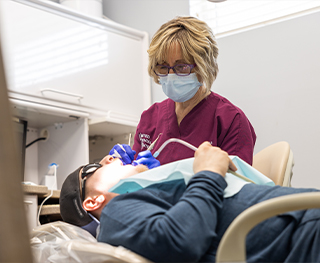 Merrillville dental team member treating a patient