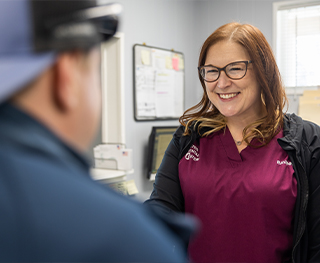 Dental team member smiling at dental patient