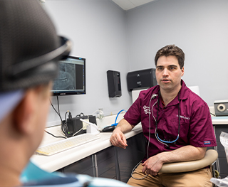 Doctor David Fried talking to dental patient in dental treatment room