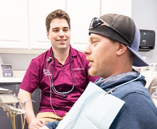 Doctor David chatting with a dental patient