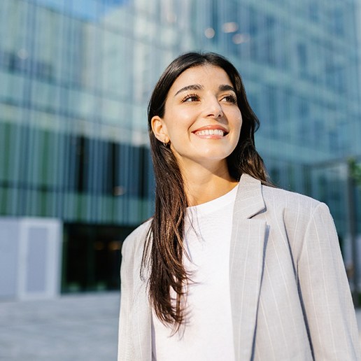 Confident woman in front of office building