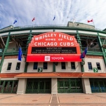 Sign on outside of stadium reading Wrigley Field Home of the Chicago Cubs