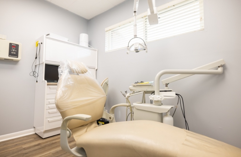 Dental chair in treatment room with window toward the ceiling