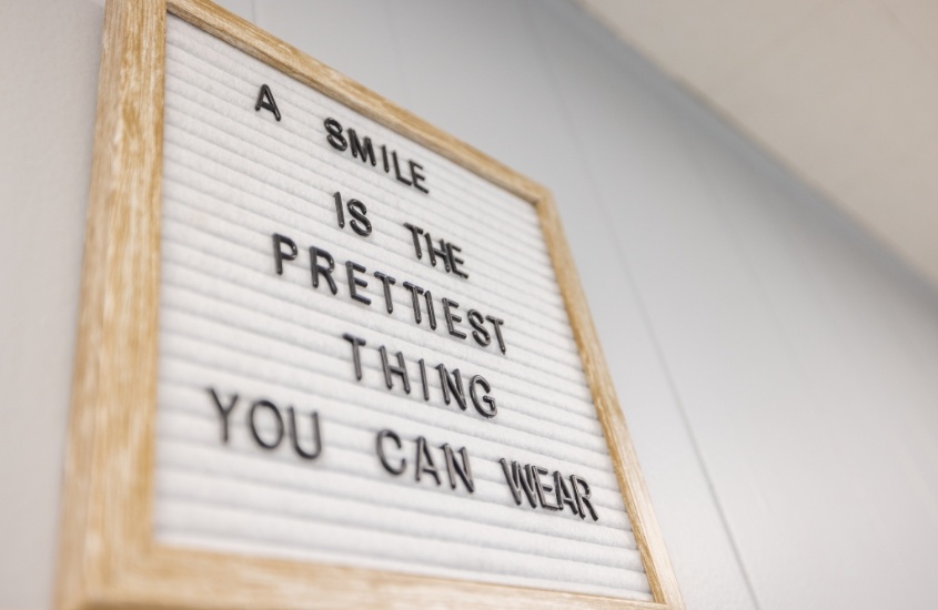 Sign that reads a smile is the prettiest thing you can wear