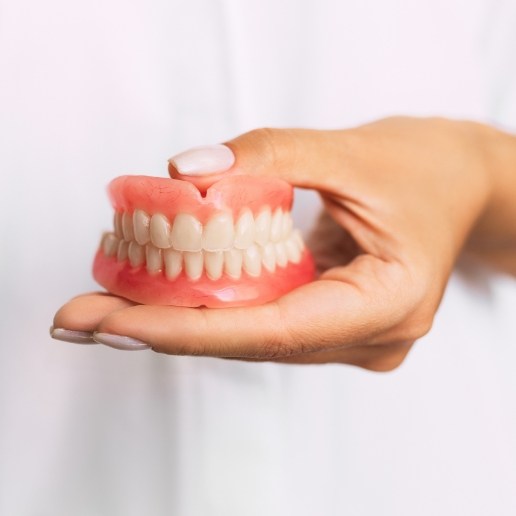 Dentist holding a set of full dentures