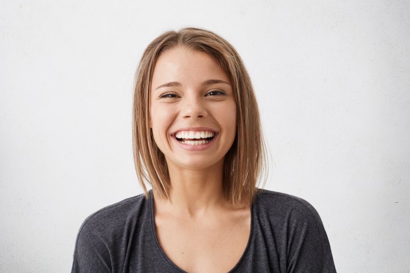 person smiling after receiving dental implants