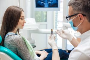 Dentist consulting with patient. 